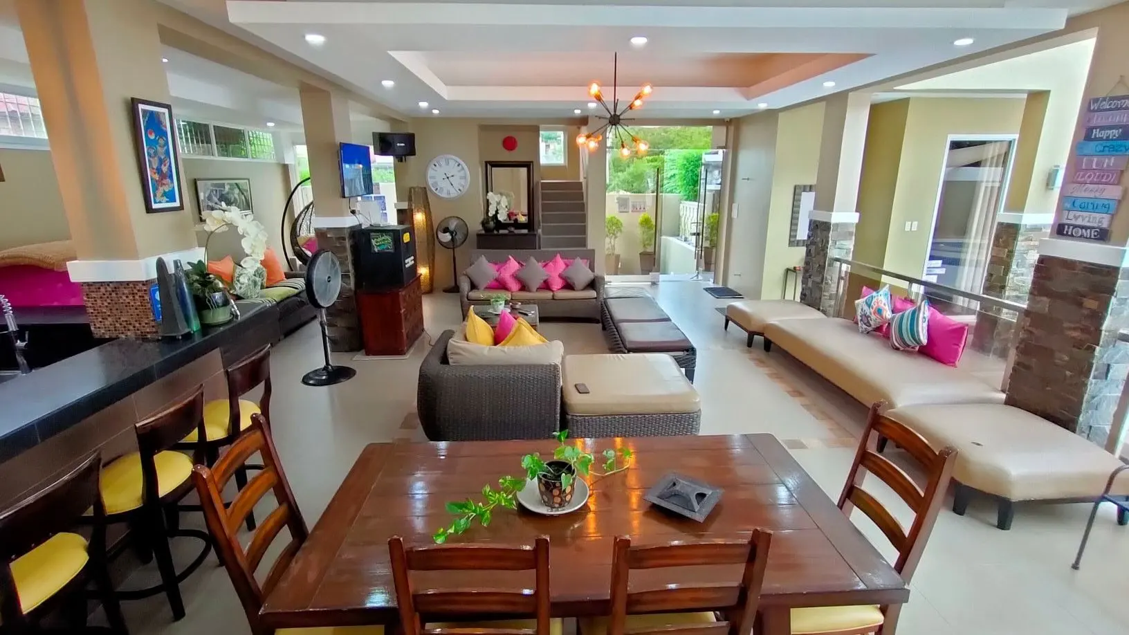 The long dining table and lounge sofas in the pavilion