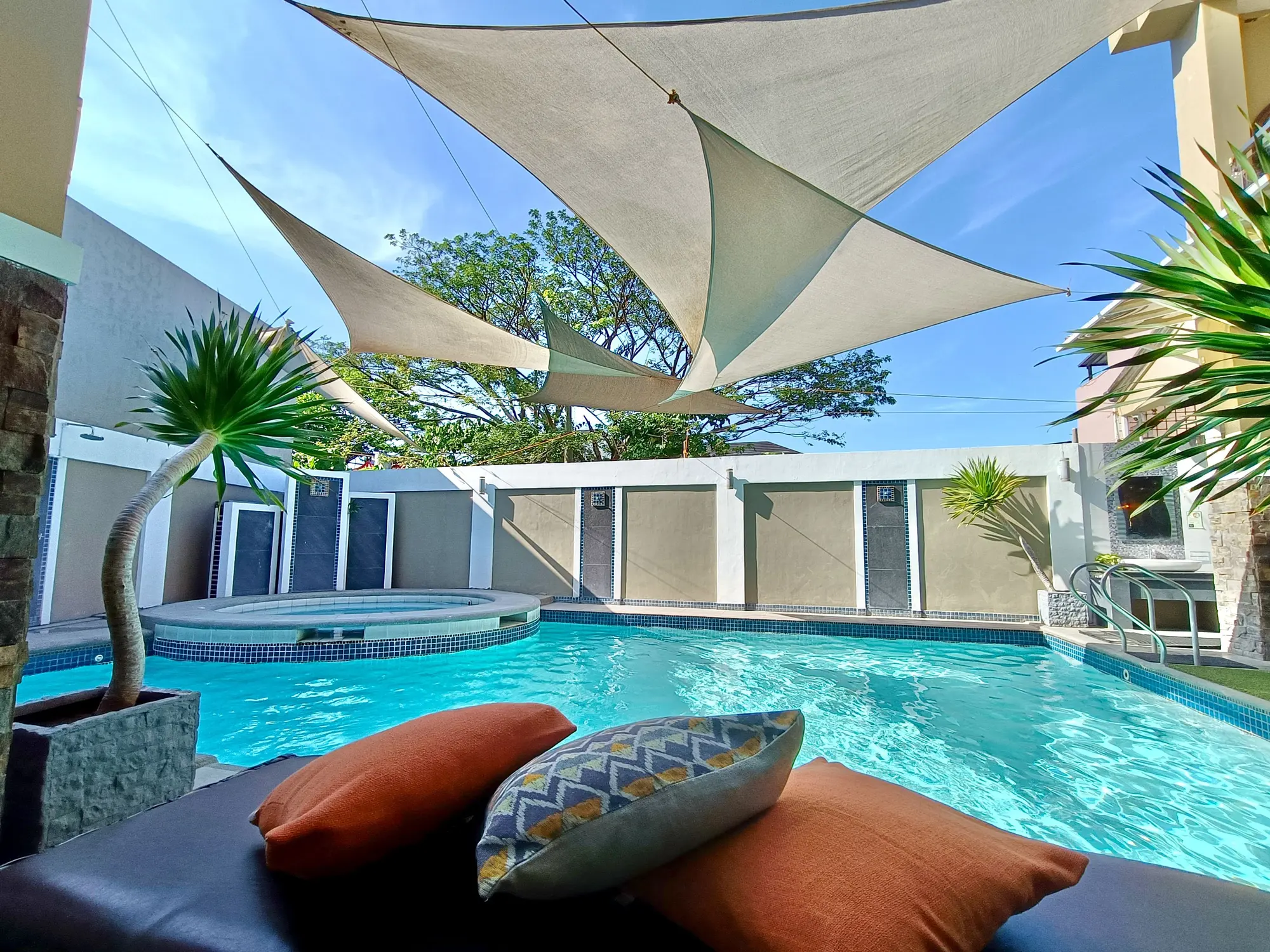 The CJC-CAR pool by day under white shade sails