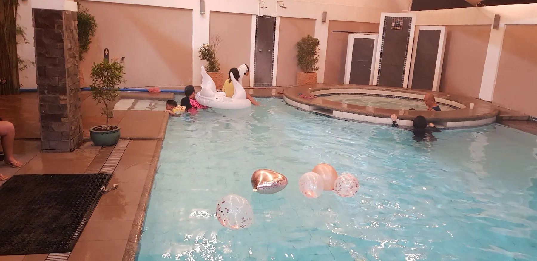 Guests swimming in the hot spring pool with floaties