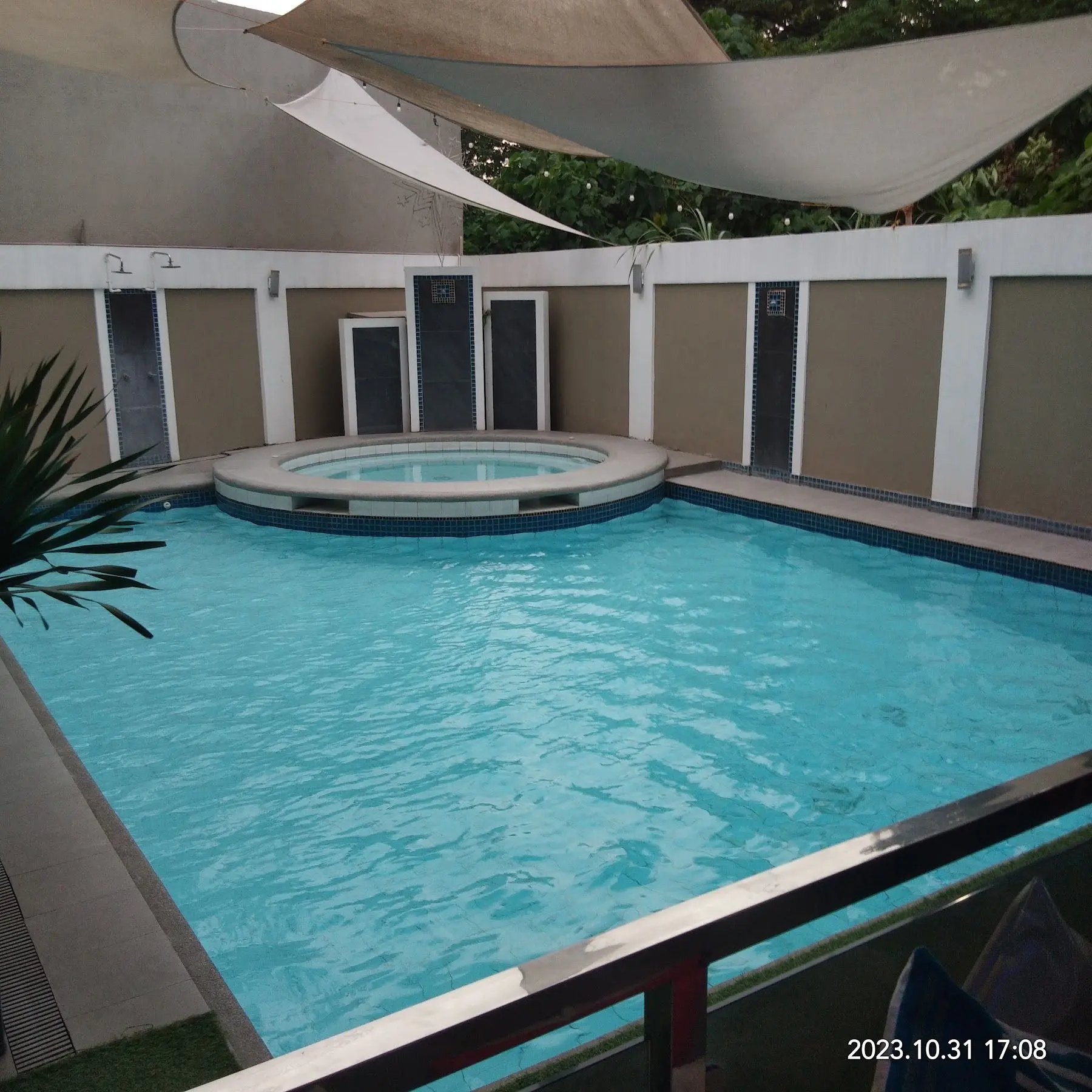 The pool and jacuzzi seen from the pavilion